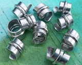 A close up view of Stylized Aluminum Dread Beads a Set of 10.