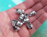 A top view of Stylized Aluminum Dread Beads a Set of 10 in hand.