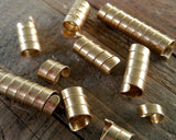 A close up set of 10 Brass Dread Beads.