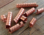 A close up top view of Varied Length of Copper Dread Beads Set of 10.