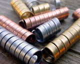 A close up view of Mixed Metal Dread Beads Set of 10 in Varied Length.