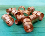 A side view of Stylized Copper Dread Beads Set of 10