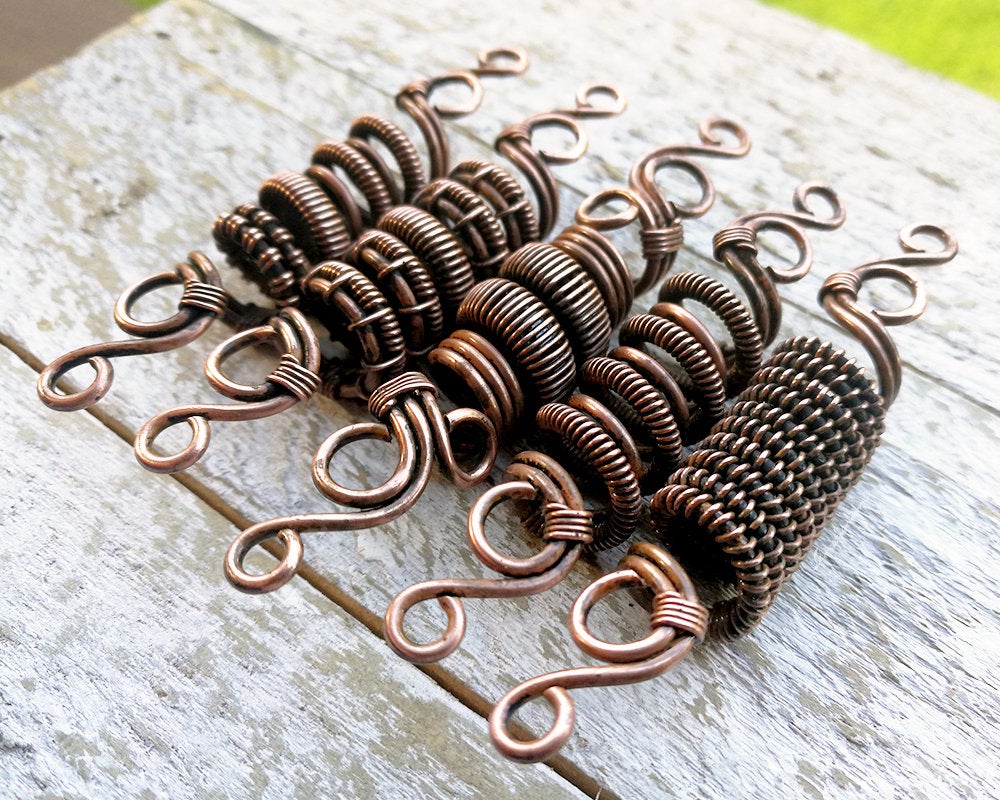 A side view of One Copper Dread Bead in different styles.