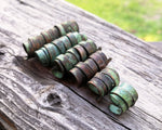 A side view of Patina Copper Dread Beads set of 6 in a row.