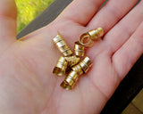 a top view of Stylized Brass Dread Beads Set of 10 in hand.