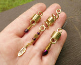 A top view of Gold Amethyst Dread Beads Set of 3 in hand.