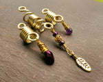 A side view of Gold Amethyst Dread Beads Set of 3.