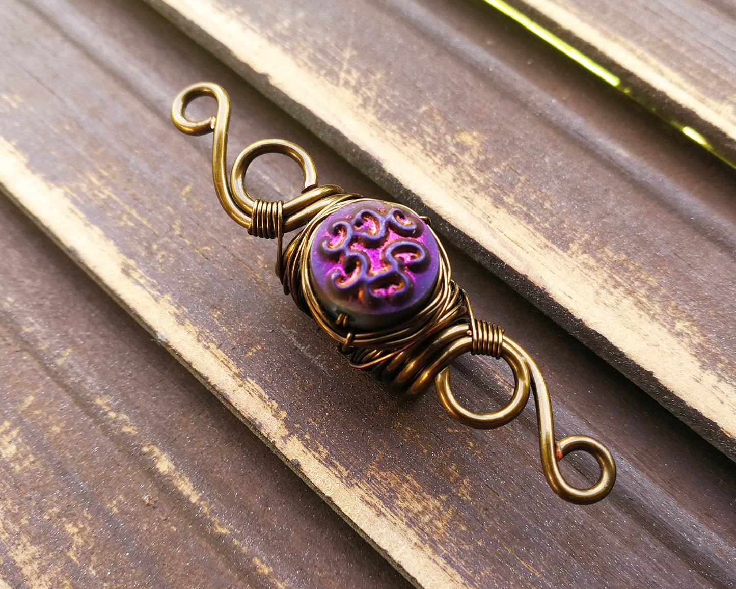 A side view of a Purple Czech Glass Dread Bead.