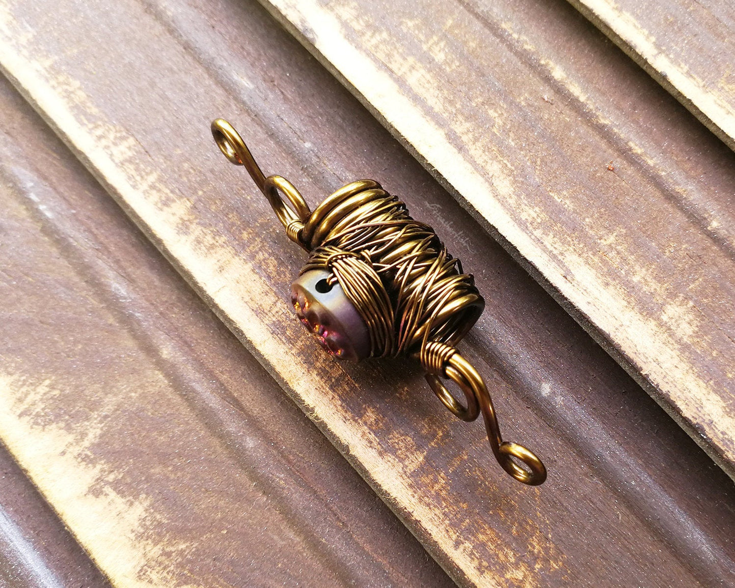 A side view of a Purple Czech Glass Dread Bead.