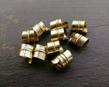 A back view of Stylized Brass Dread Beads Set of 10.