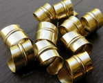 A close up view of Stylized Brass Dread Beads a Set of 10.
