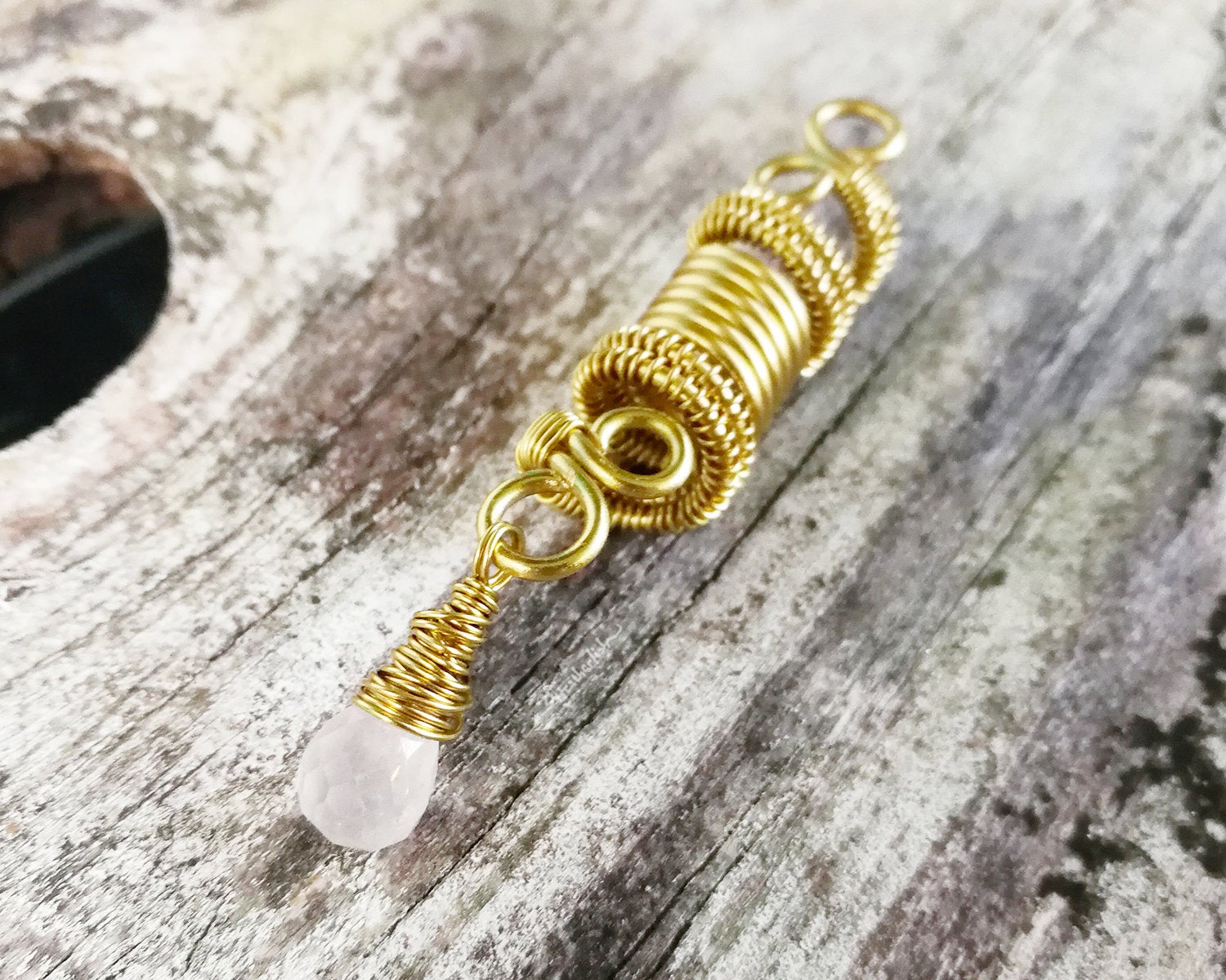 A side view of a Rose Quartz Dread Bead.