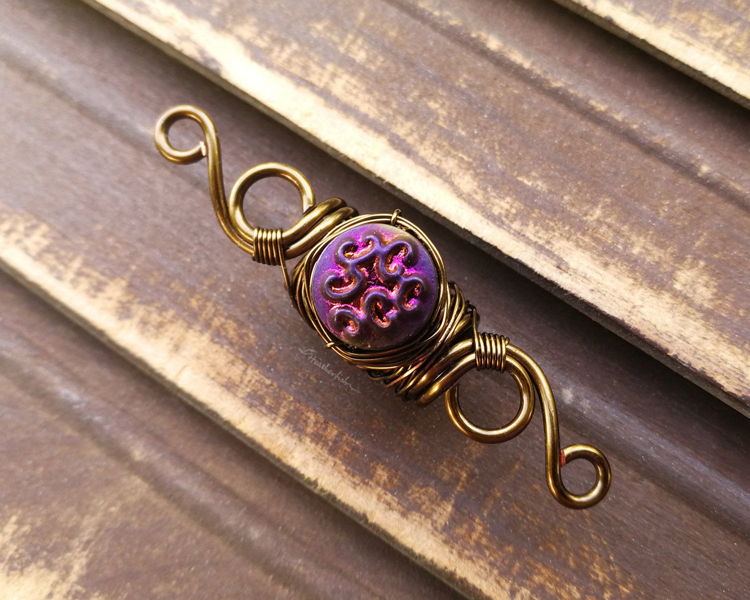 A top view of a Purple Czech Dread Bead.