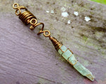 A close up view of a Green Kyanite Dread Bead. 