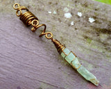 A close up view of a Green Kyanite Dread Bead. 