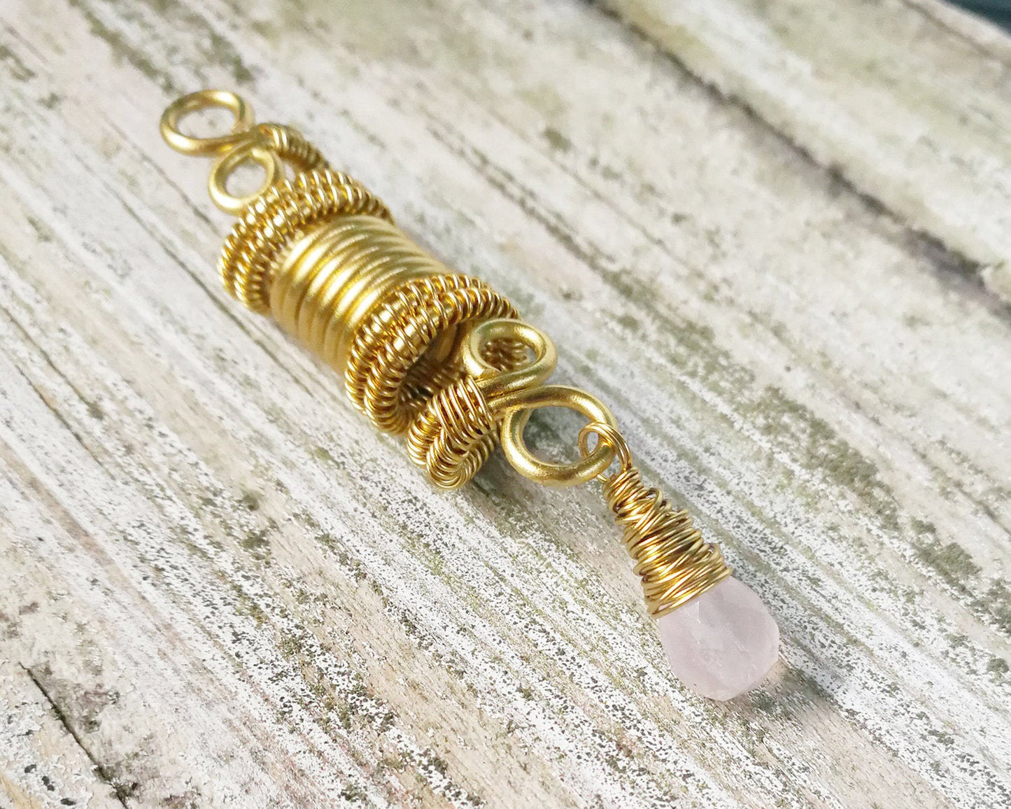 A side view of a Rose Quartz Dread Bead.