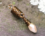 A top view of a Champagne, Antique Brass Dread Bead