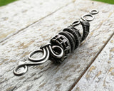 A side view of a Silver Filigree Dread Bead.