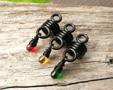 A back view of Rasta Dread Beads Set of 3 Glass Drops.