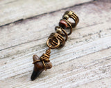 A side view of a Shark Tooth Dread Bead with Wood Accents.