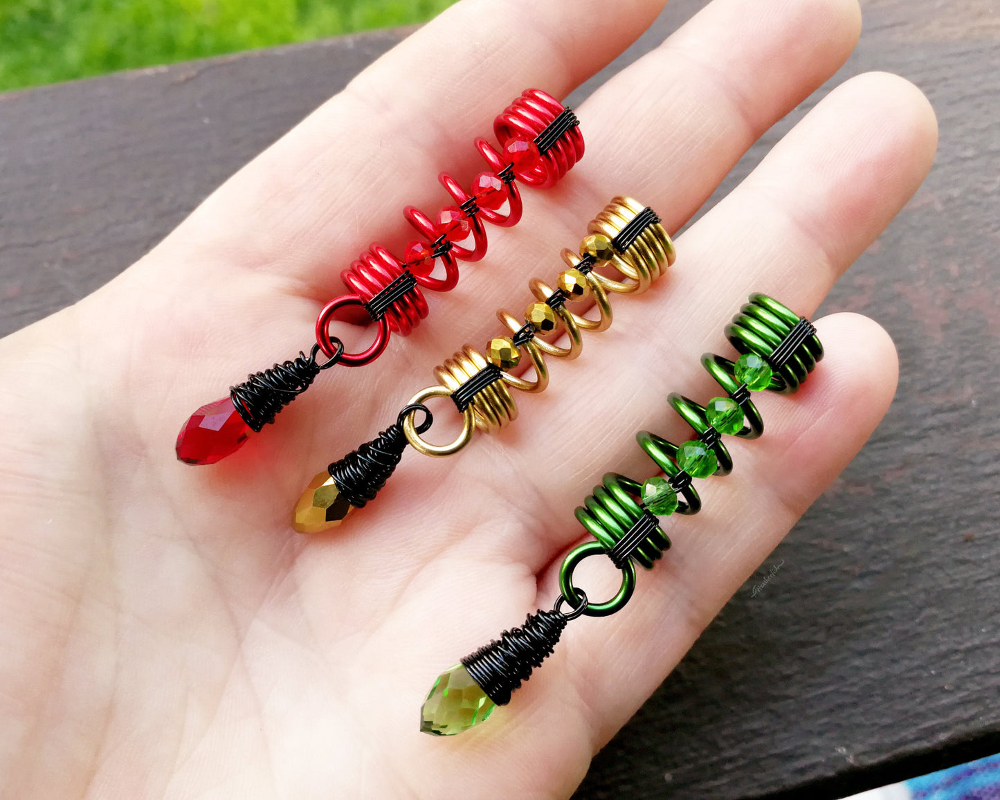 A top view of Multi-tone Rasta Dread Beads Set of 3 in hand.