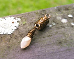 A front view of a Champagne, Antique Brass Dread Bead.