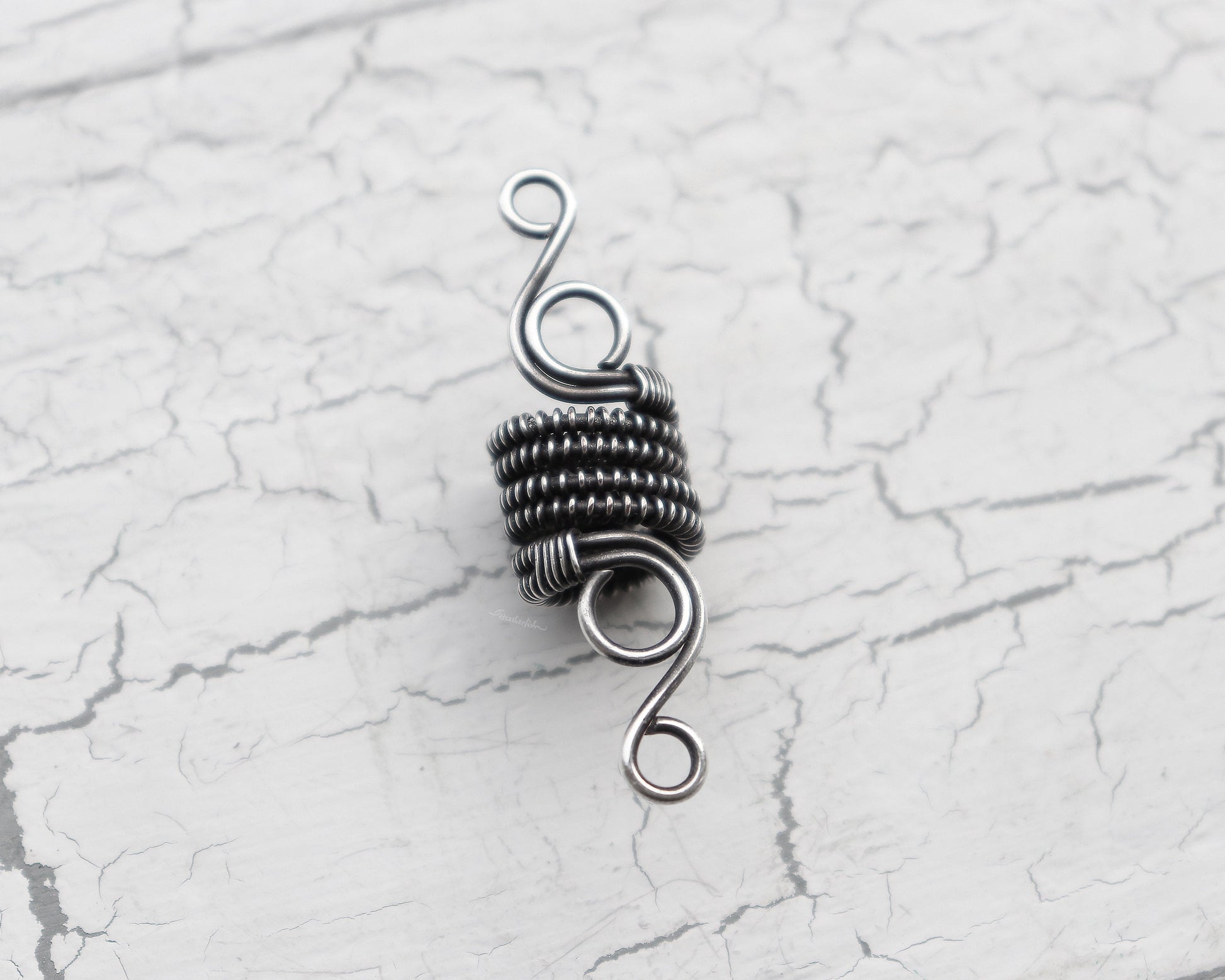 A top view close up of a Elegant Silver Dread Bead.