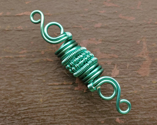 A close up view of a Woven Aqua Dread Bead.