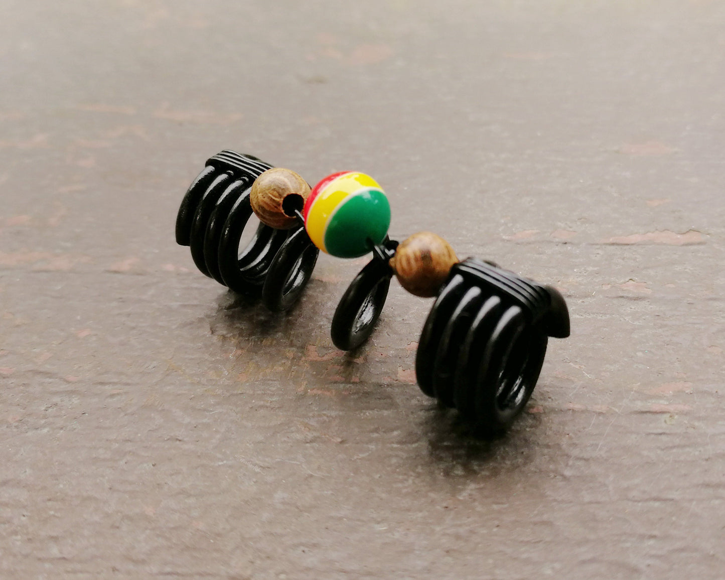 A side view of a Striped Rasta Dread Bead.