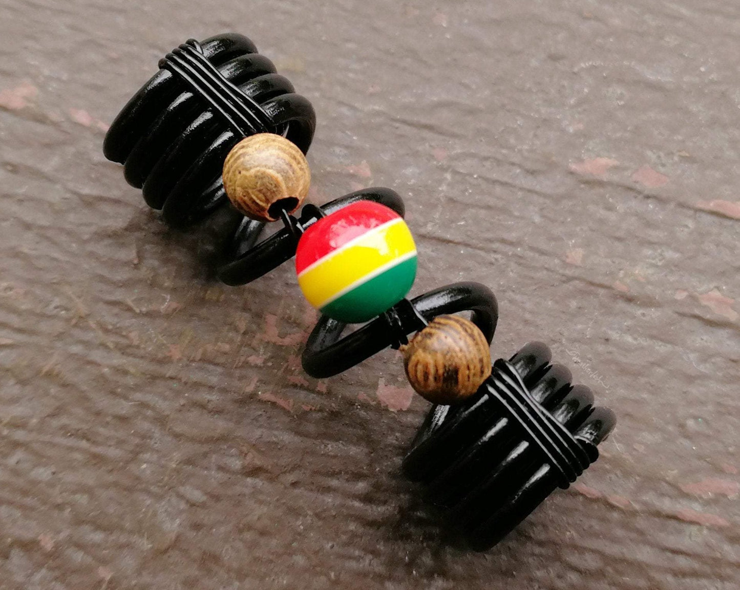 A close up view of a Striped Rasta Dread Bead.